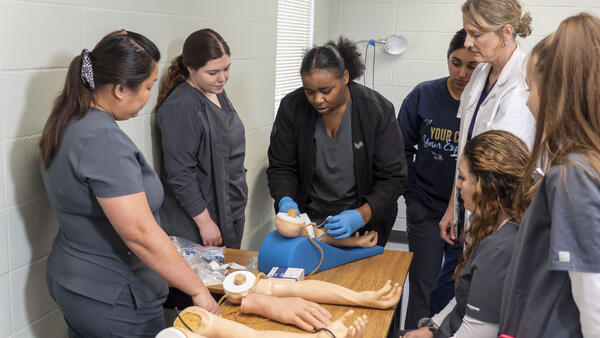 Medical assistant students learn to draw blood